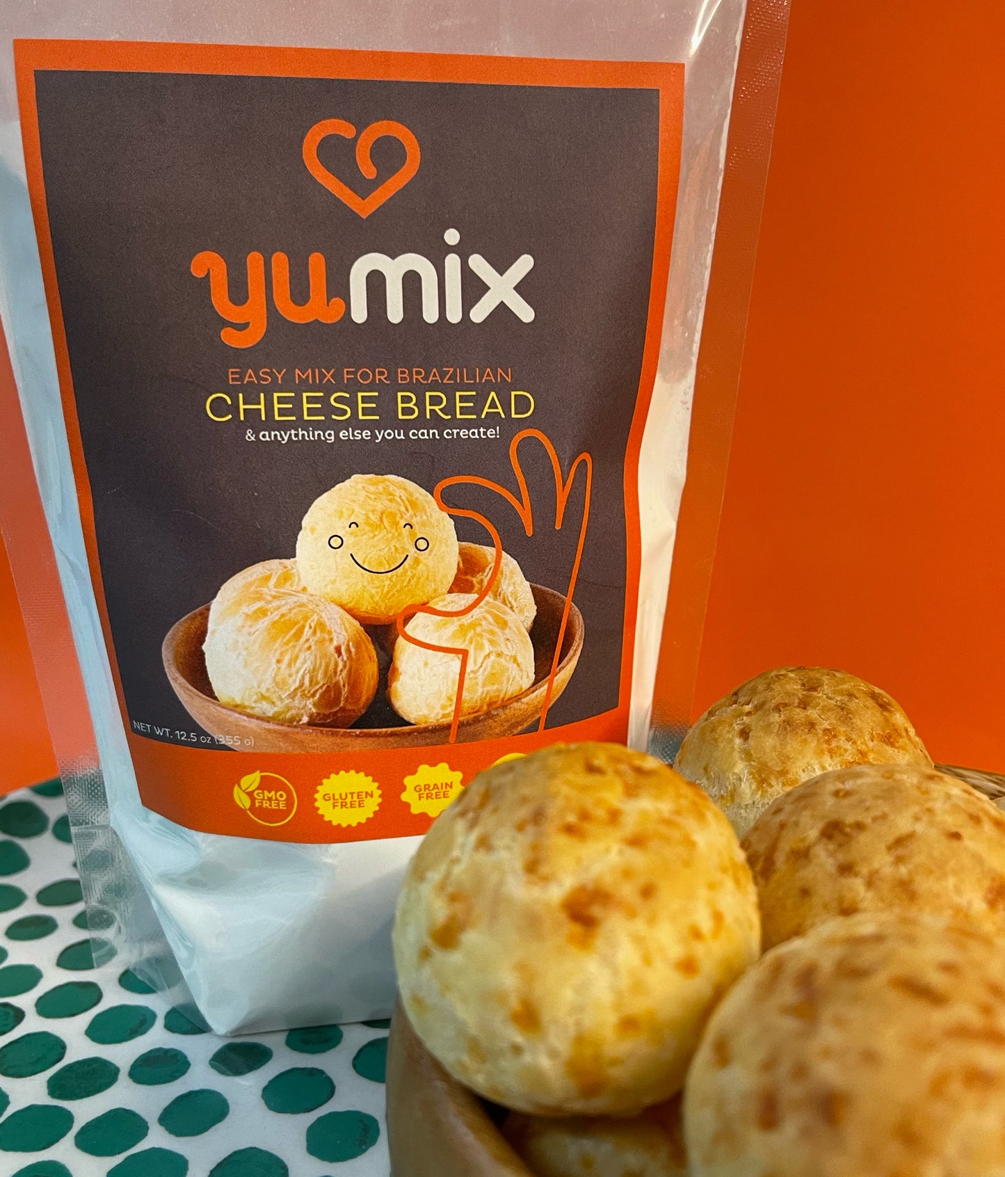 Yumix packaging on a table with some baked cheese reads on the side